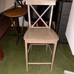 wooden chair with a cross-back design, typically used for dining or casual seating. $30 pickup and cash