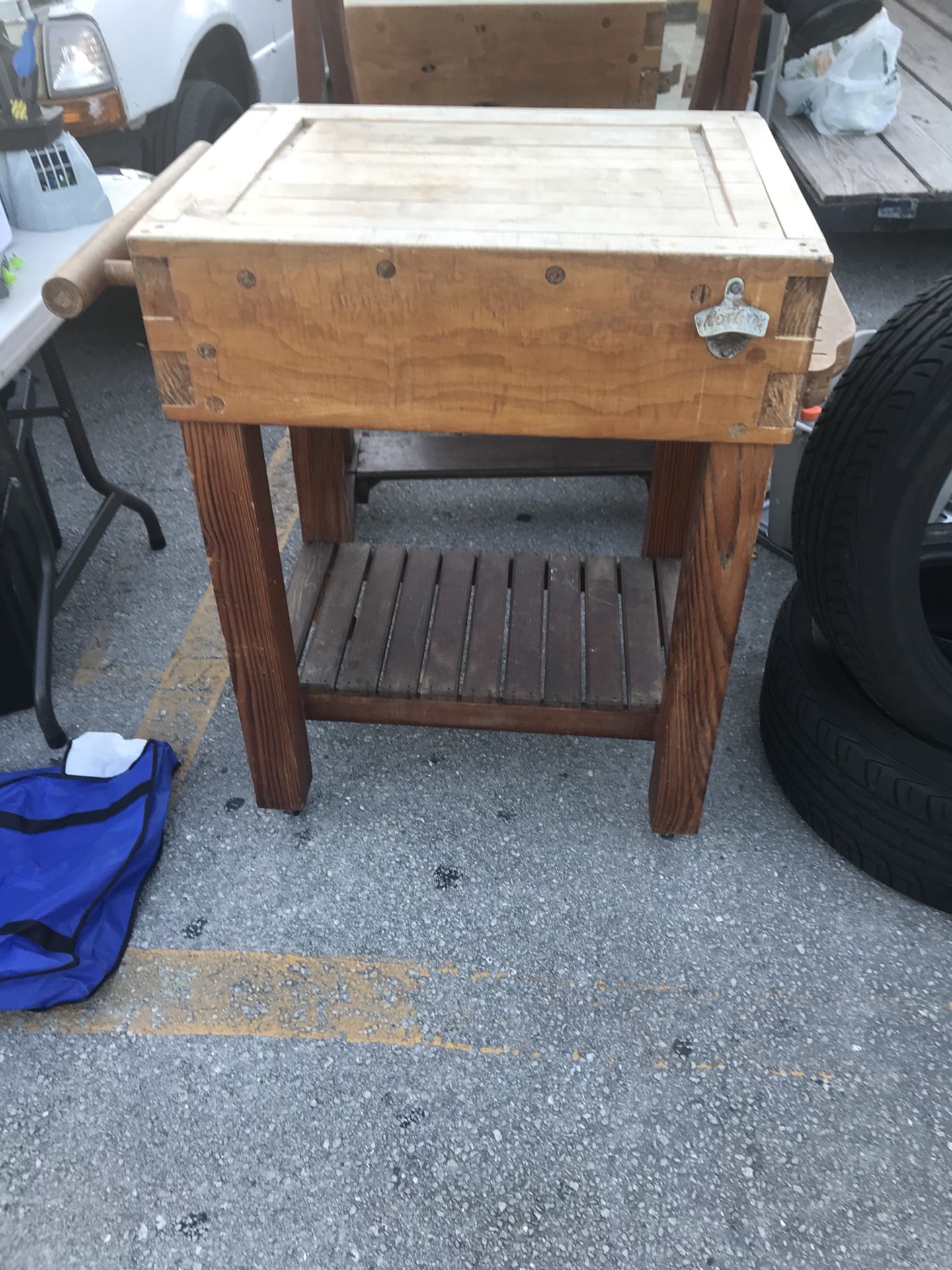 Vintage butcher block cutting table on wheels with dovetail joints and dowels making it a real work of art along with a old Coca Cola bottle opener m