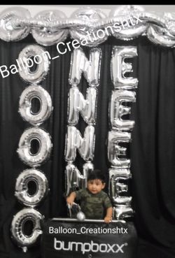 One. Year old balloon backdrop celebration