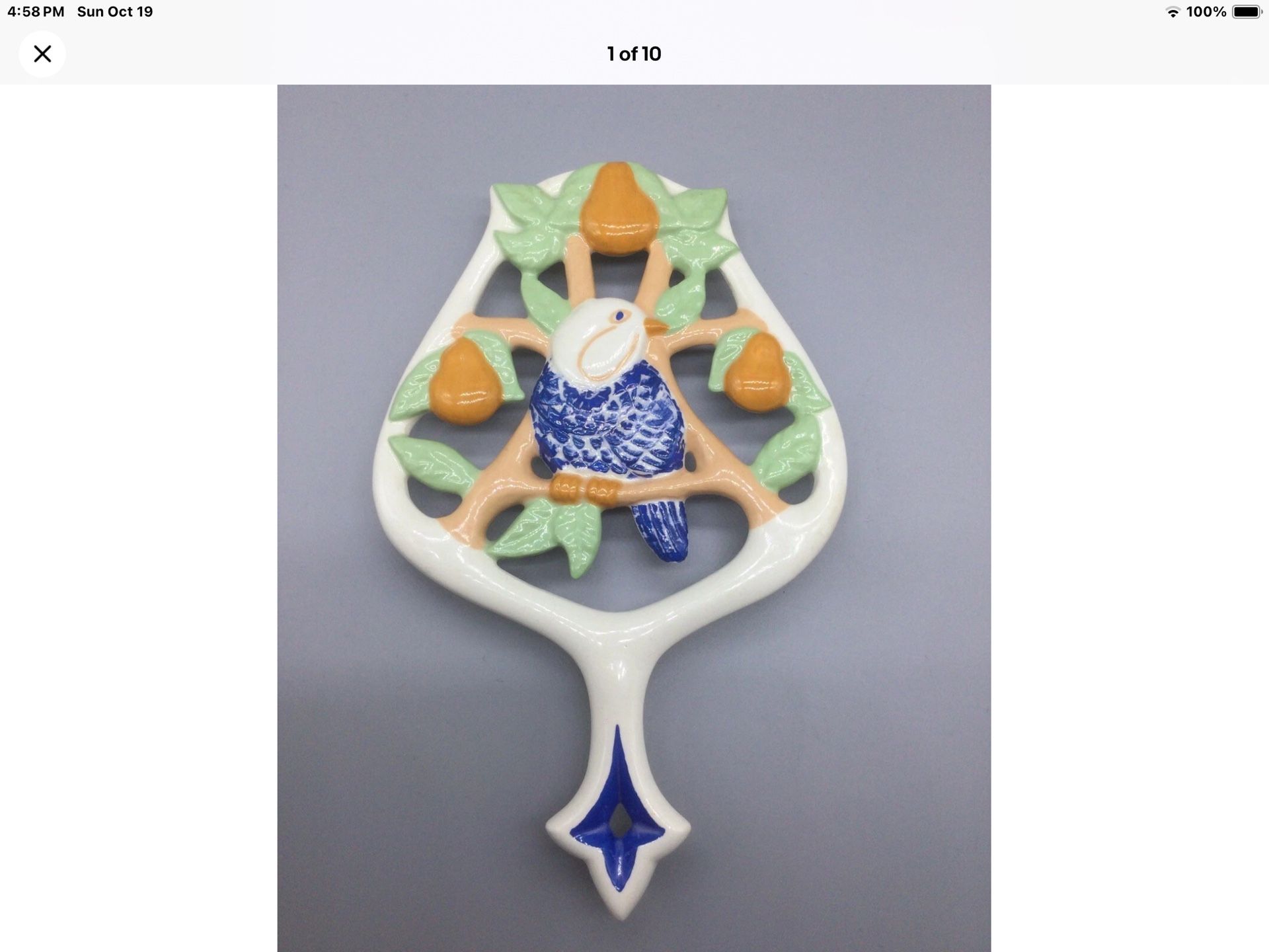 Vintage 1970 Signed Artisan White Ornate Ceramic TRIVET Blue Parrot Orange Fruit Jungles    It measures 8.5"x 6".    Signed and dated 1970.  Very uniq