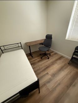 Standing desk, ergonomic office chair, and bed frame