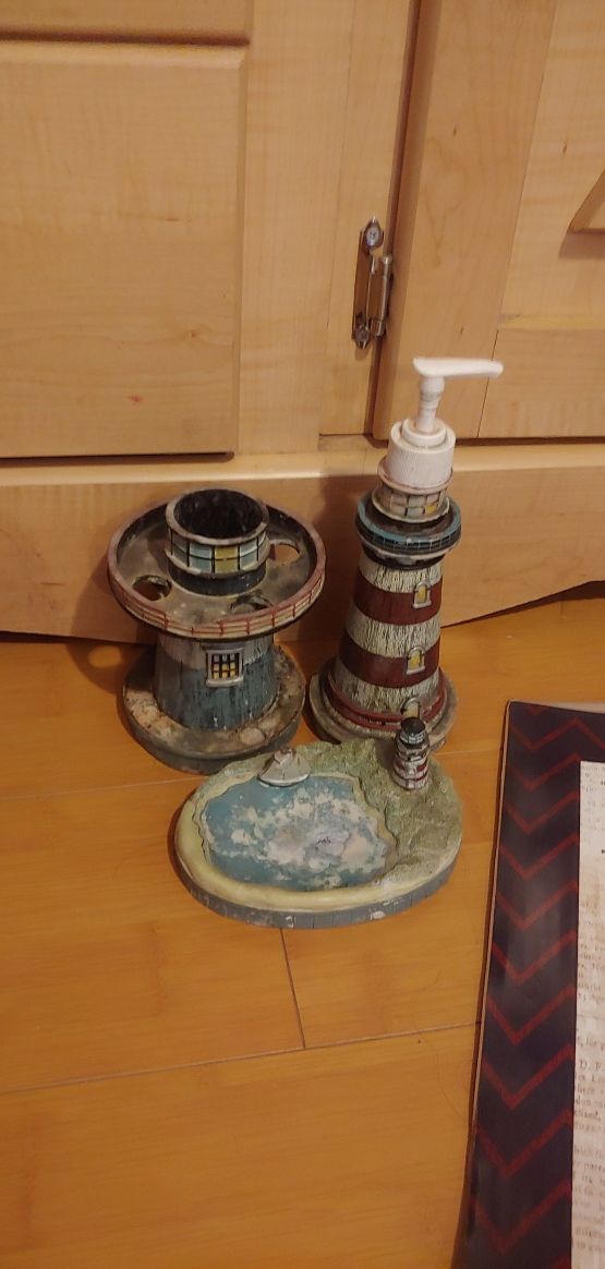 Nautical, light house decor for bathroom. Needs a wash but good condition. Light house soap dispenser, soap tray and toothbrush holder.