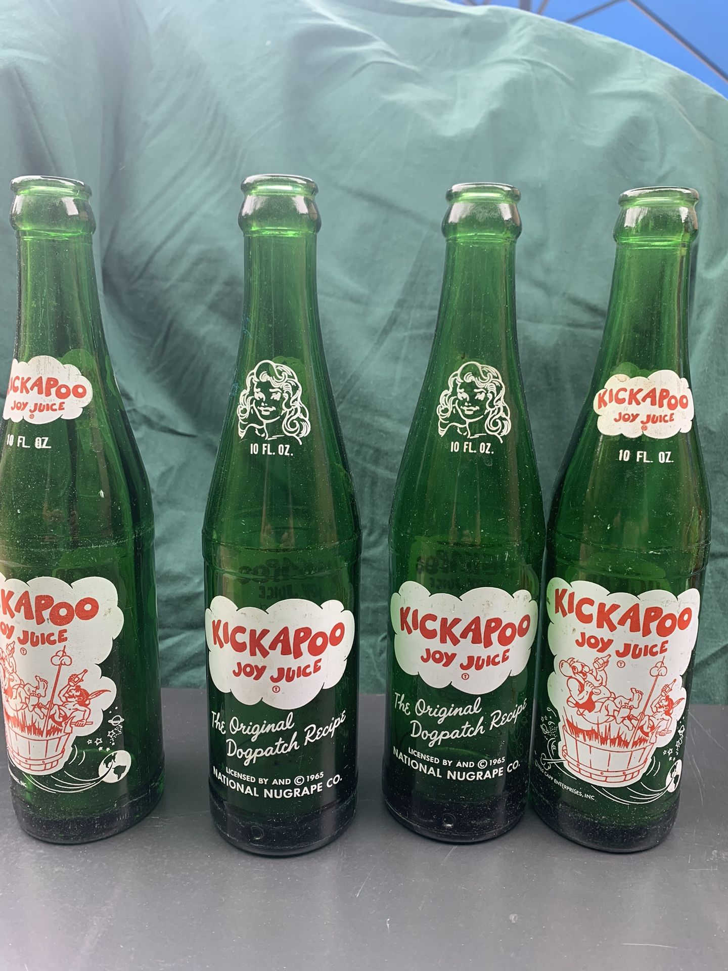 Four 1965 Kickapoo Joy Juice Bottles