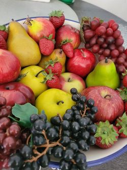 Artificial fruit in Italian like setting bowl