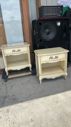 Vintage cream-colored nightstand features a classic French Provincial design