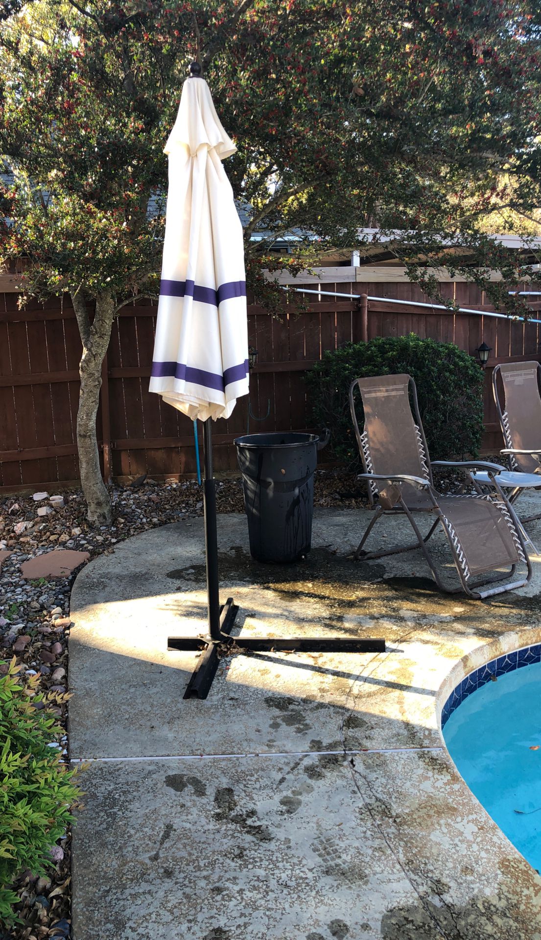 Pool umbrella with stand.