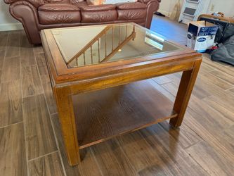 2 wood and glass tables