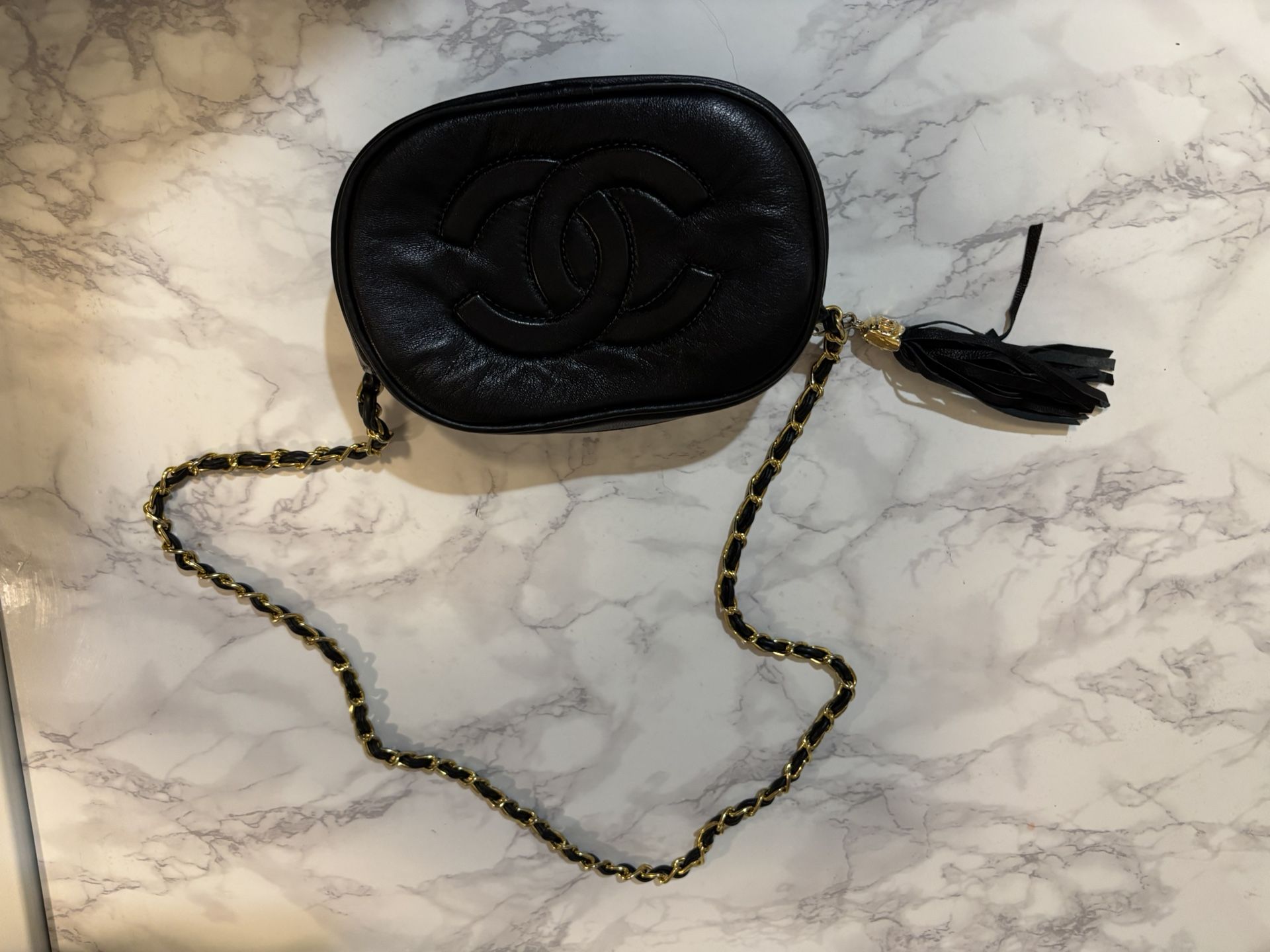 vintage black leather Lambskin camera bag with a tassel and chain-link shoulder str