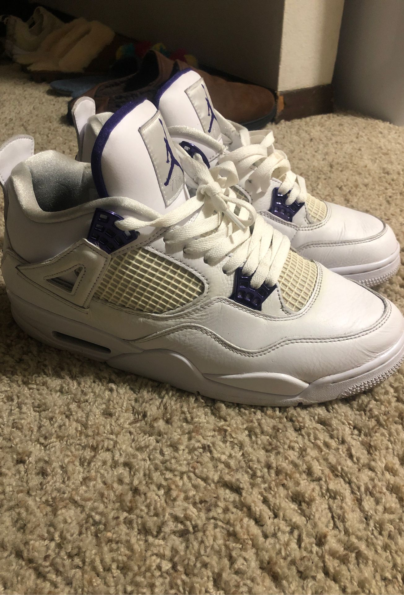 white and purple jordan 4's