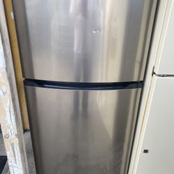 Refrigerator/freezer made by Frigidaire 5 feet tall with icemaker. $300.