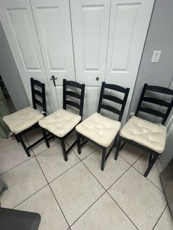 IKEA solid wood black chairs with white  cushions. Check description.