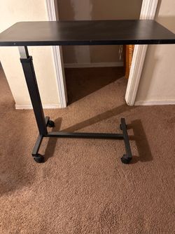 Medical bed with adjustable table