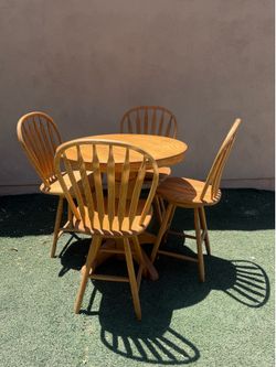Real wood dining table and 4 swivel chairs