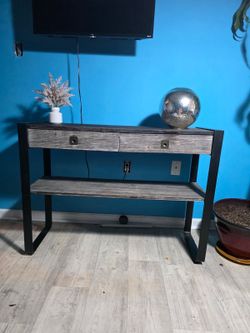 Sofa table, mirror and plant