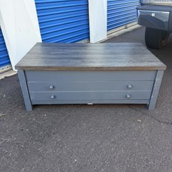 Lift-top coffee table; lightly used, with a minor surface blemish that does not affect functionality