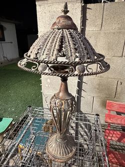Vintage cast iron candle lamp with an ornate leaf design