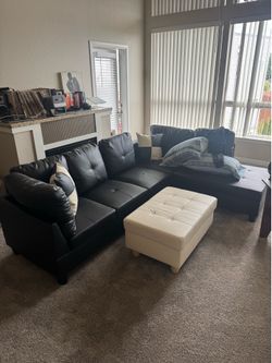 Black leather sectional couch and ottoman