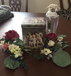 Angel tin and floral bottle and mirror picture. Floral candle ring swags.