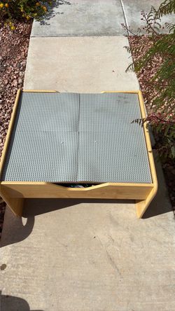 Children’s Lego table filled with multiple sets