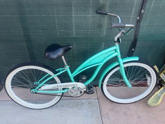 Mint green single-speed beach cruiser bicycle with a curved step ...