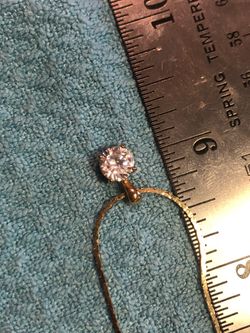 Gold tone pendant with white pendant