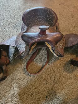 This vintage, hand-tooled Western leather saddle.