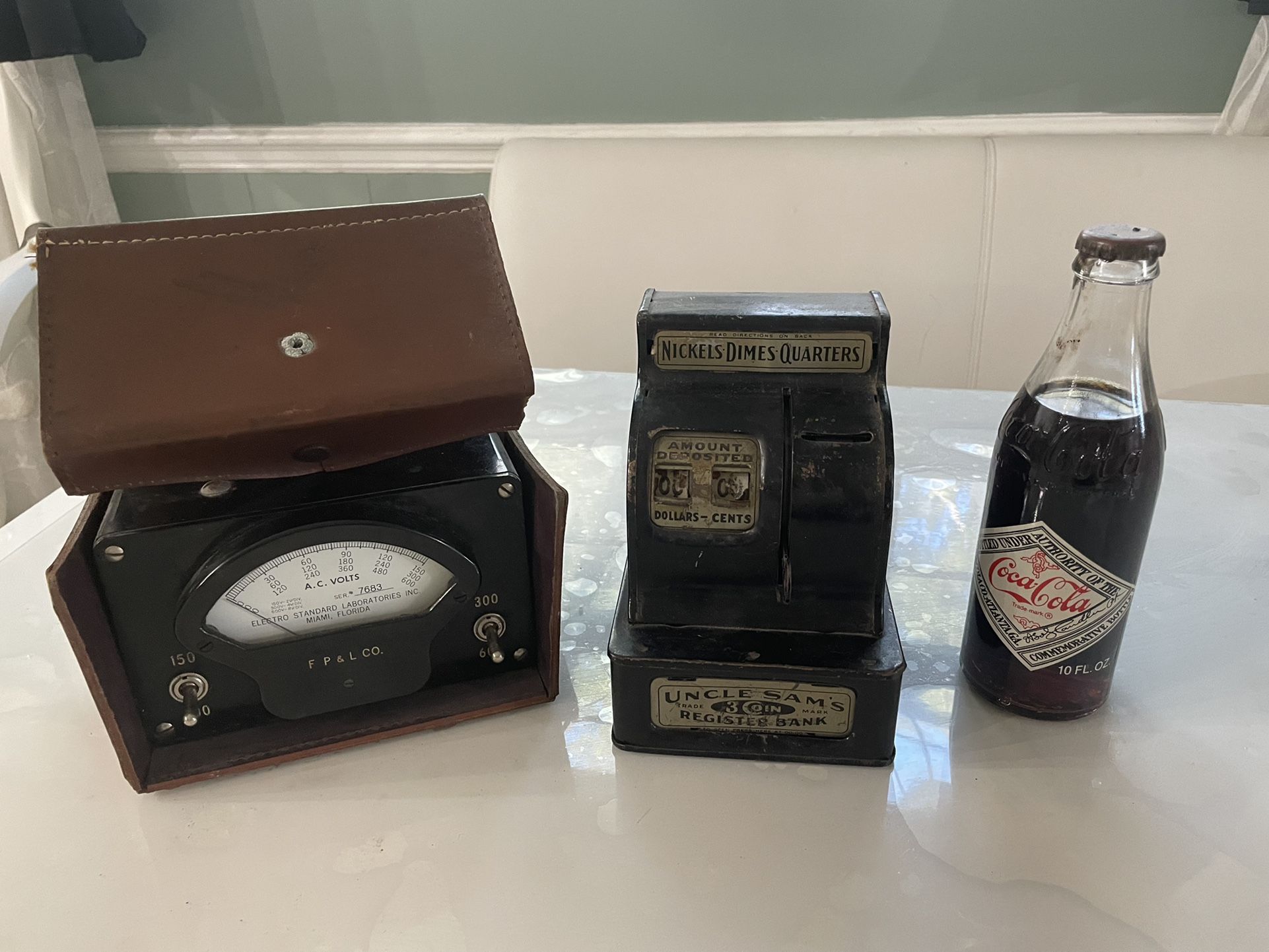 Antique Electrical Meter Reader, a Coin Machine and a bottle of coke