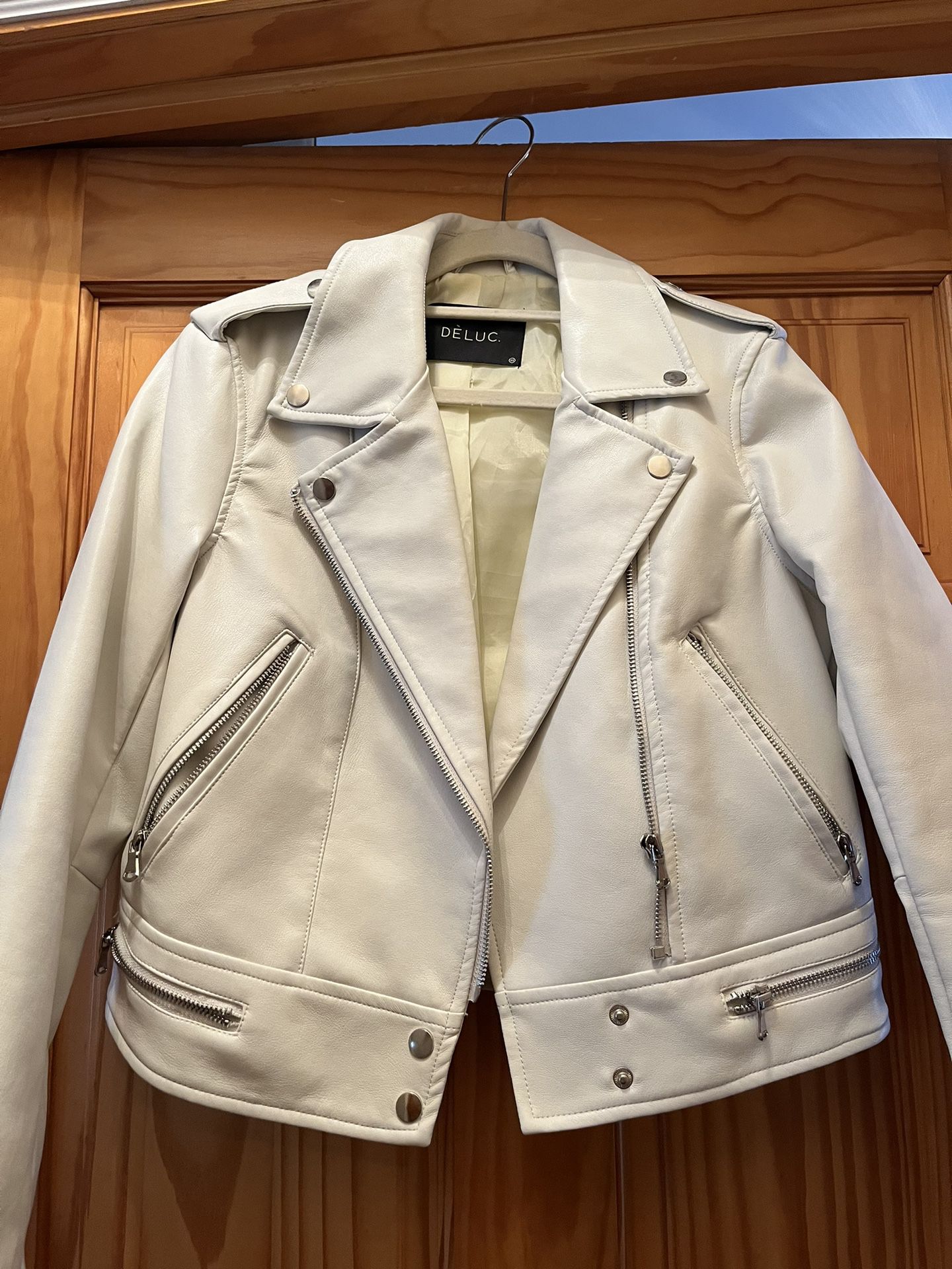 Cool leather jacket. Deluc Jacket. Off white. Size xs Never been worn, no tags. Lots of cool details. Zippers  Pockets. Studded. Stylish color in the 