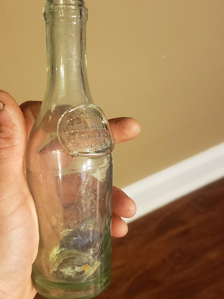 antique French glass bottle. crudely applied glass label