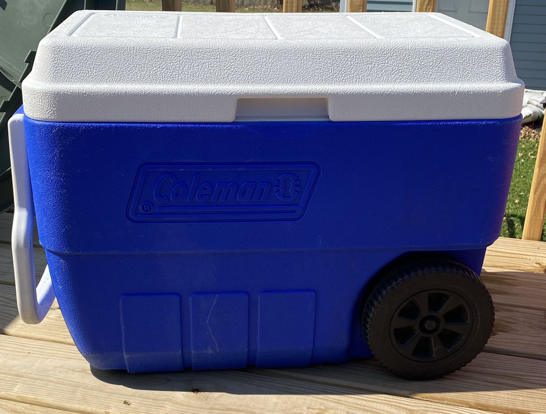 Almost brand new Coleman 5850 blue cooler with handle and wheels