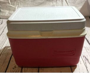 Red Rubbermaid cooler with white lid.