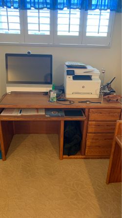 Solid oak desk with detachable top section.