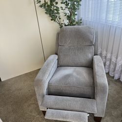 Fabric Pushback Recliner chair with removable sides on the back.