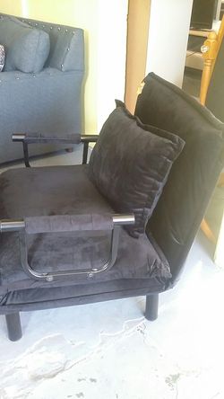 Upholstered chair converts twin bed