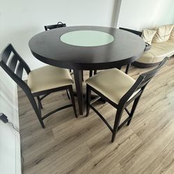 High top dining table wth four leather chairs