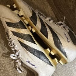 of Adidas Predator Elite soccer cleats, likely in the White, Black, and Gold colorway