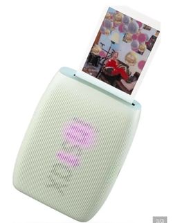 Portable Fujifilm instant photo printer in mint green