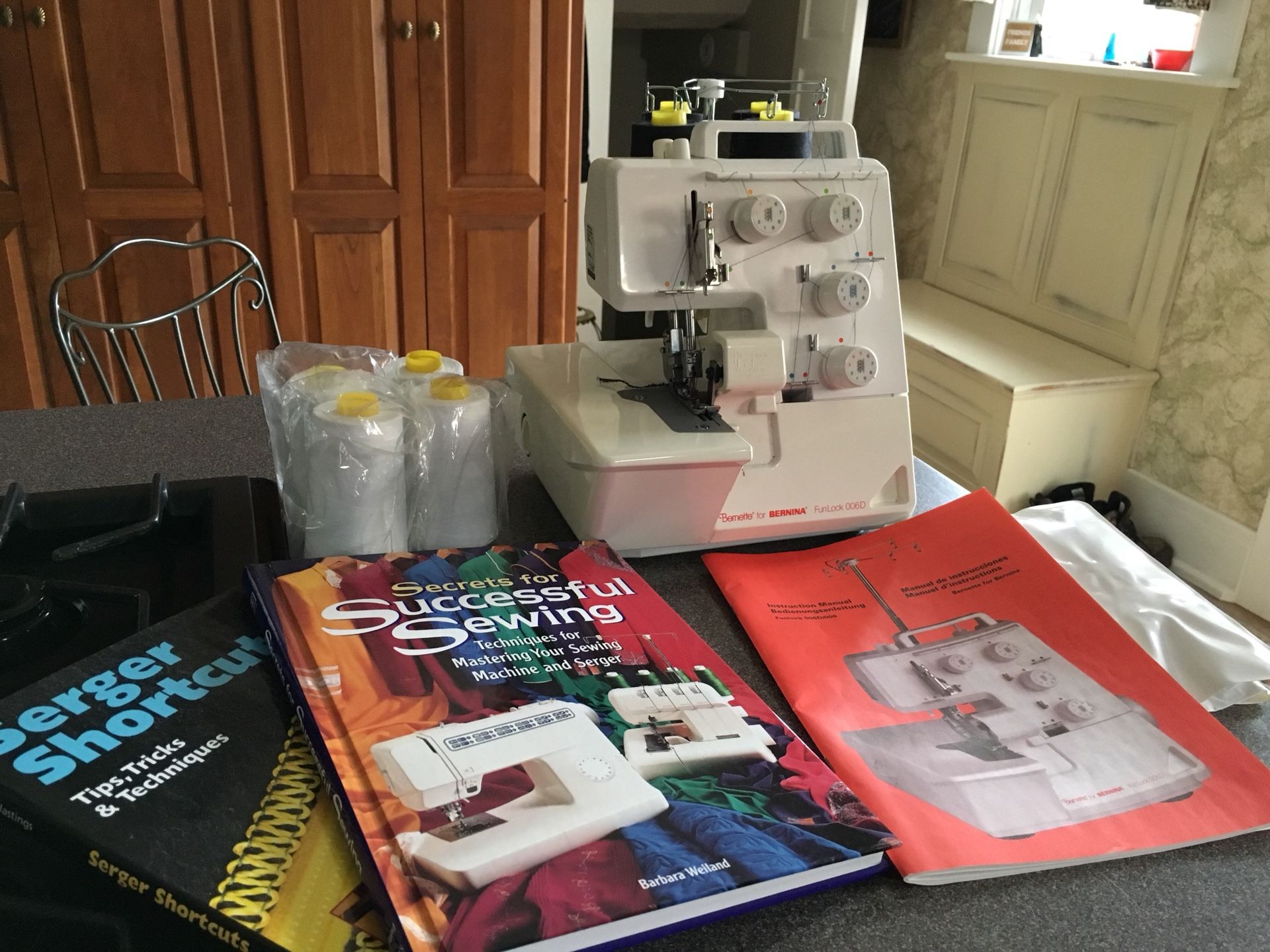 Bernina Bernette FunLock 006D Serger with original parts and manual. Additional 8 cones of thread and 2 Serger Books.