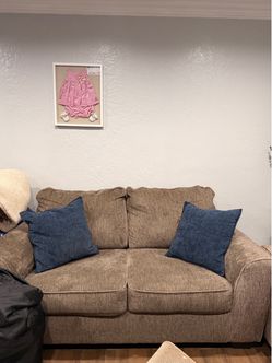Tan Loveseat with Blue Throw Pillows