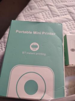 Portable mini printer with 2 cartridges.