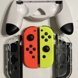 NINTENDO JOYCONS (LI(R) NEON RED AND YELLOW W/ COVERS & JOYPAD