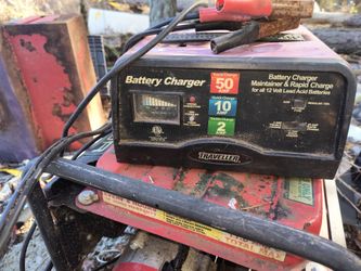 Traveller Battery Charger (similar to model designs like the Cen-Tech/Traveller 50/10/2A 12V charger) with an analog amp meter and jumper cable clamps