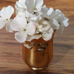 Lovely Floral Arrangement: Silver & White Flowers, Gold foiled Glass Vase. Overall Size: 18” x 10”. Vase: 6 H x 4.25” (top), 4.25” (bottom), 3” (base)