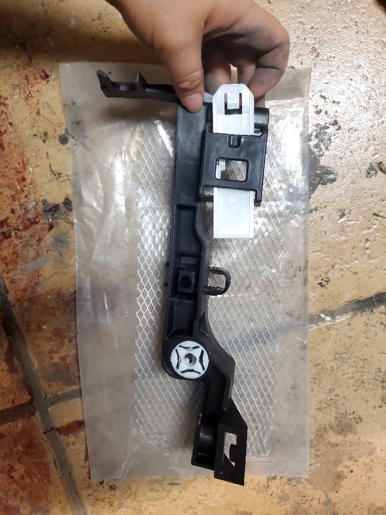 headlight mounting bracket for a Dodge Ram truck.