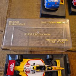 4 collectible die cast race cars in display cases