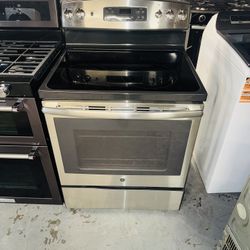 GE stainless steel electric stove with a receipt for a 60-day warranty