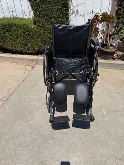 Black Manual Wheelchair with Leg Rests  with legs extended    18 inches wide