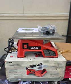 This is a red SKIL  7-Inch Wet Tile Saw with a stainless steel tabletop
