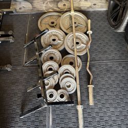 Olympic weights 255lbs total plus 7ft 45lbs bar plus curl bar and weights tree
