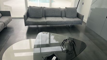 Two large fabric living room sofas with chrome legs based.